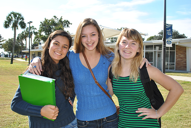 Three Female student  on the grassy area outside Natural Sciences.